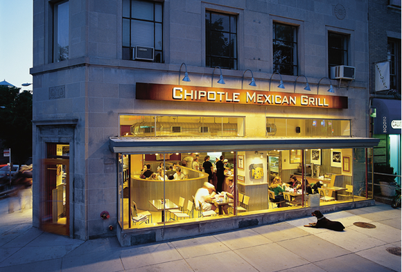 The exterior of a Chipotle Mexican Grill at dusk.