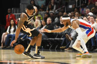 Atlanta Hawks guard Jeff Teague reaches for the ball lost by Detroit Pistons guard Bruce Brown, right, during the first half of an NBA basketball game Saturday, Jan. 18, 2020, in Atlanta. (AP Photo/John Amis)