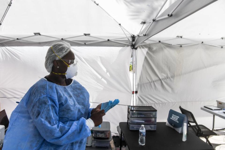 A medical staff member prepares for testing at the Aardvark Mobile Health's mobile coronavirus testing truck in Miami Beach.