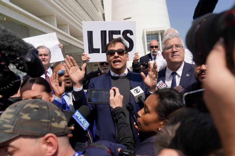 Rep. George Santos leaves the federal courthouse in Central Islip, New York, on Wednesday after he pleaded not guilty to charges he duped donors, stole from his campaign and lied to Congress.