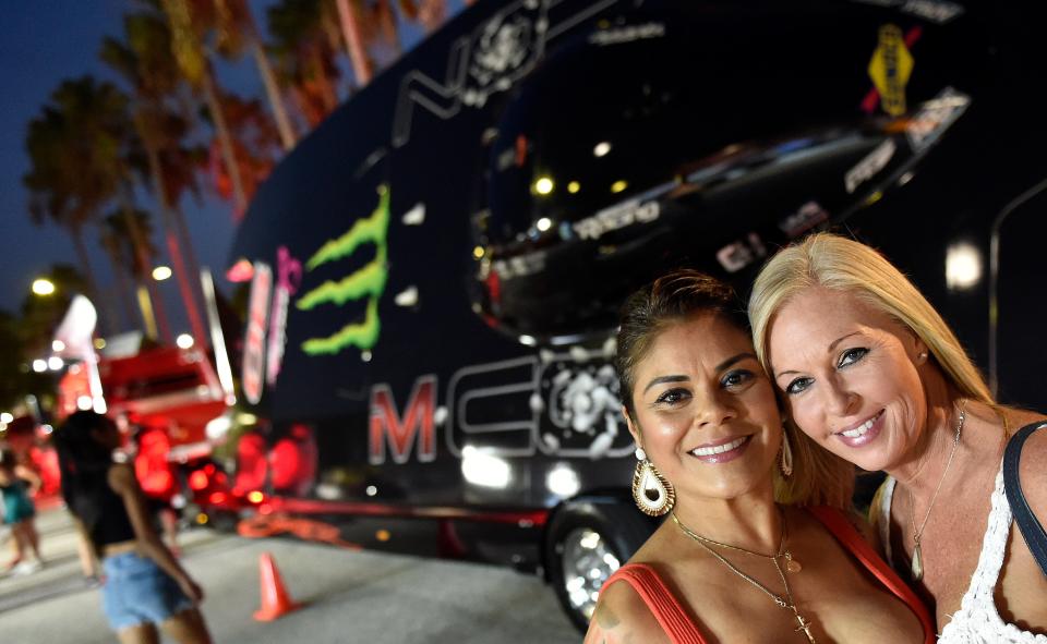 Having some fun at the pit party, Mandy Ramgopaul and Leah Cary both of Sarasota, with the Class 1 Monster Energy powerboat before the 39th Offshore Sarasota Powerboat Grand Prix in early July. The event is a popular Sarasota attaction.