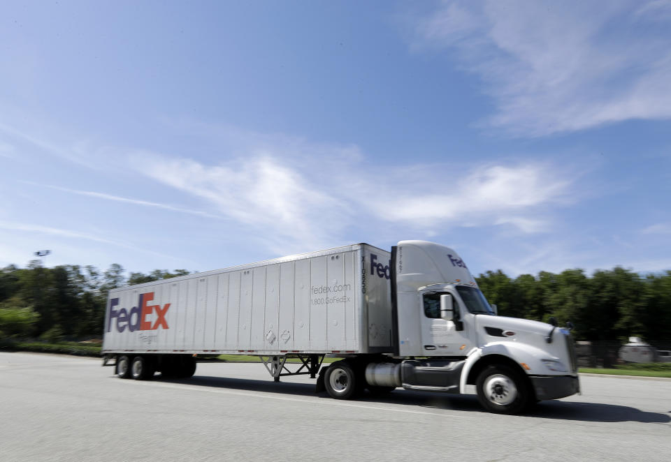 A FedEx truck leaves a distribution center in Greensboro, N.C., Tuesday, June 25, 2019. FedEx is suing the United States government over export rules it says are virtually impossible to follow because it handles millions of packages a day. (AP Photo/Chuck Burton)