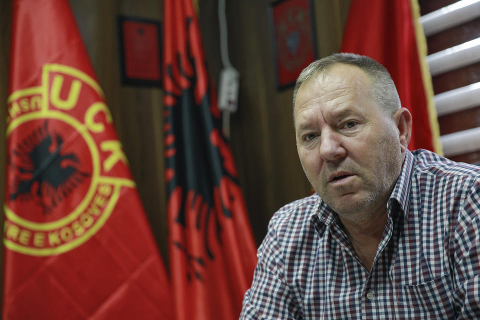 Hysni Gucati head of the War Veterans Organization of the Kosovo Liberation Army speaks during an interview with The Associated Press regarding his co-fighter former Kosovo Liberation Army commander Salih Mustafa after news of his arrest, in capital Pristina, Thursday, Sept. 24, 2020. A special international court said Thursday that a former commander of the separatist fighters in Kosovo's 1998-1999 war has been arrested as part of a war crimes and crimes against humanity probe stemming from the conflict with Serbia. (AP Photo/Visar Kryeziu)