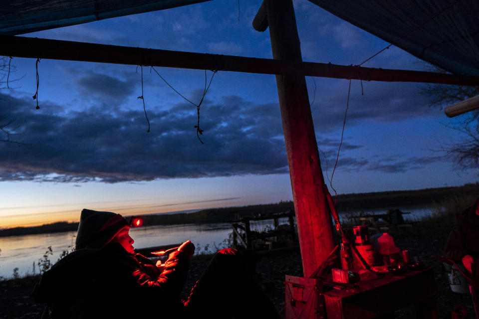 Kori Williams, 17, eats goose soup at the Stevens' family hunting camp after a day spent looking for moose along the Yukon River Tuesday, Sept. 14, 2021, near Stevens Village, Alaska. Two salmon species have all but disappeared from Alaska's Yukon River this year, prompting the state to shut down fishing in an effort to save them. (AP Photo/Nathan Howard)