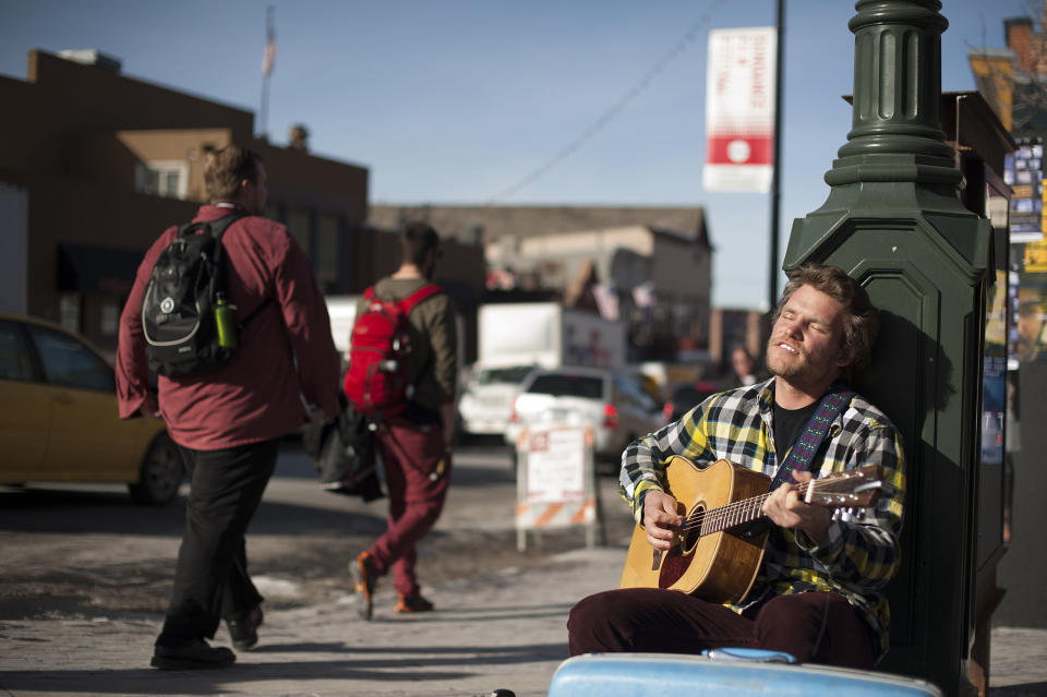 A busker performs on Main Street during the Sundance Film Festival on Thursday, Jan. 16, 2014, in Park City, Utah. The independent film festival runs from Jan. 16 –26, 2014. (Photo by Arthur Mola/Invision/AP)