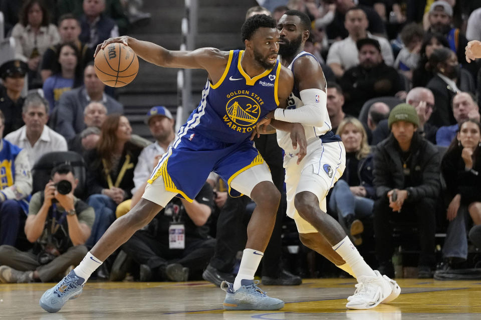 Golden State Warriors forward Andrew Wiggins (22) drives against Dallas Mavericks forward Tim Hardaway Jr. during the second half of an NBA basketball game in San Francisco, Tuesday, April 2, 2024. (AP Photo/Jeff Chiu)