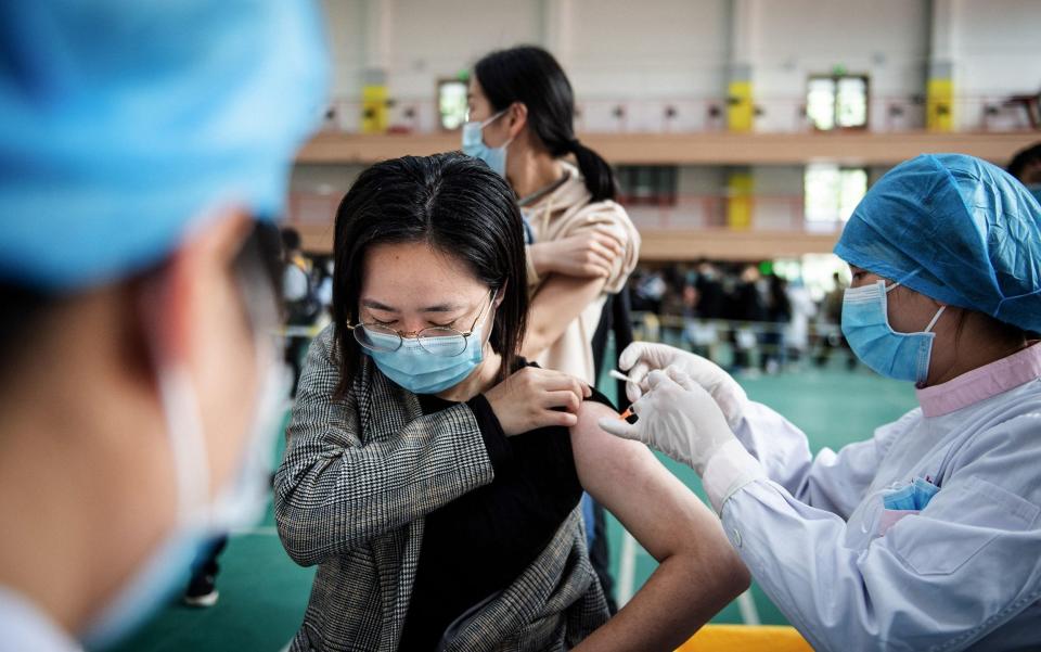 A student receives a Covid vaccine at a university in Wuhan, the city where the virus is believed to have erupted - GETTY IMAGES