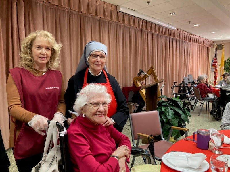 Linda Bear (left), is pictured with Sister Erin and resident Betty Whitesell. Bear, a member of the nonprofit group St. Augustine Home Guild is volunteering at the banquet hall at Little Sisters of the Poor St. Augustine Home in the Saint Vincent neighborhood on Indianapolis' northside.