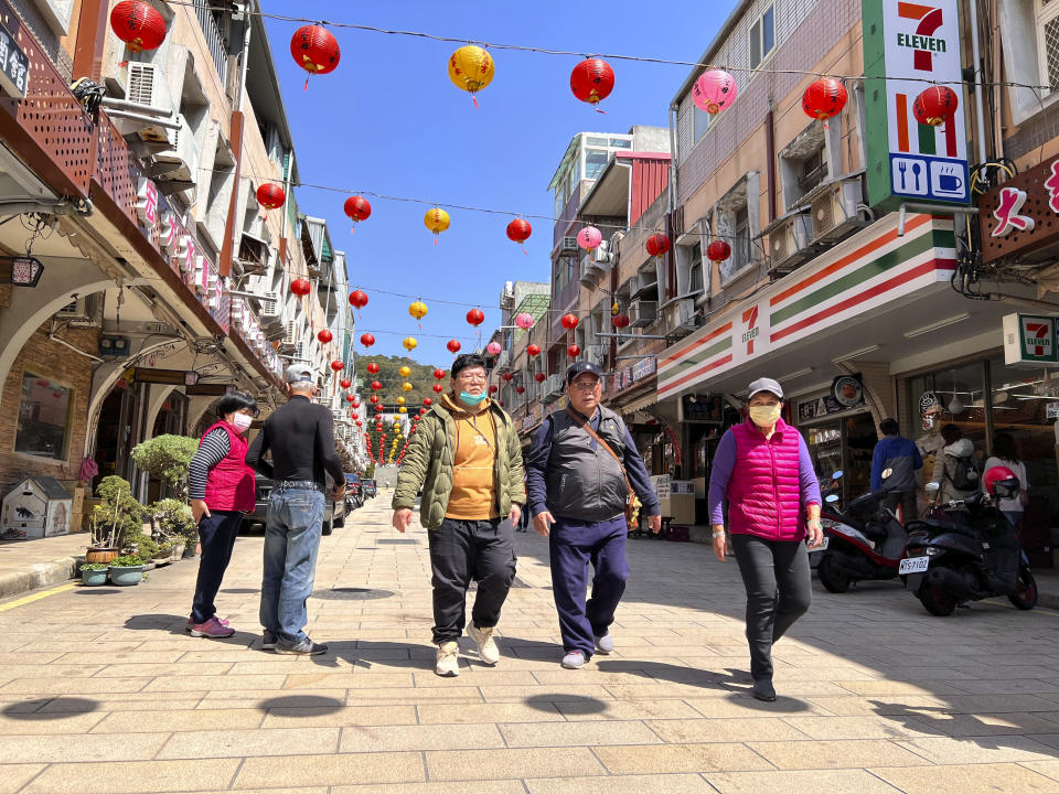 Tourists were seen walking on the street in the shopping district on Nangan, part of Matsu Islands, Taiwan on Tuesday, March 7, 2023. Thousands of residents of Taiwan's outlying islands near the Chinese coast have been without the internet for the past month. Chunghwa Telecom, Taiwan's largest service provider and owner of the two submarines cables that serve Matsu islands, says Chinese vessels cut them. (AP Photo/Johnson Lai)