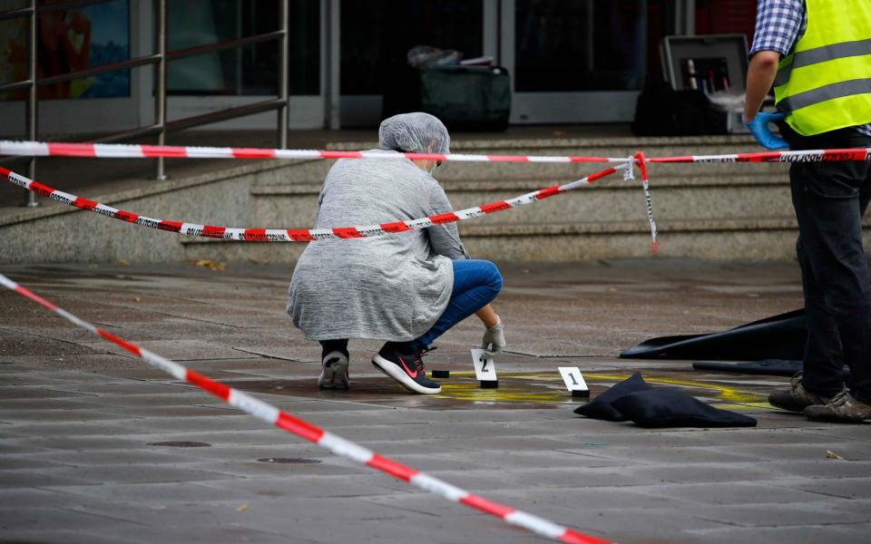 Police investigators work at the crime scene after a knife attack in a supermarket in Hamburg - Credit: Morris Mac Matzen/Reuters