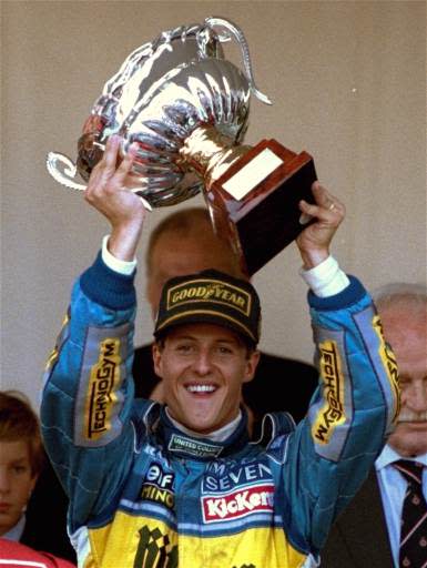 Michael Schumacher of Germany raises the victory cup after winning the Monaco Grand Prix Sunday May 28, 1995. (AP Photo/Lionel Cironneau)