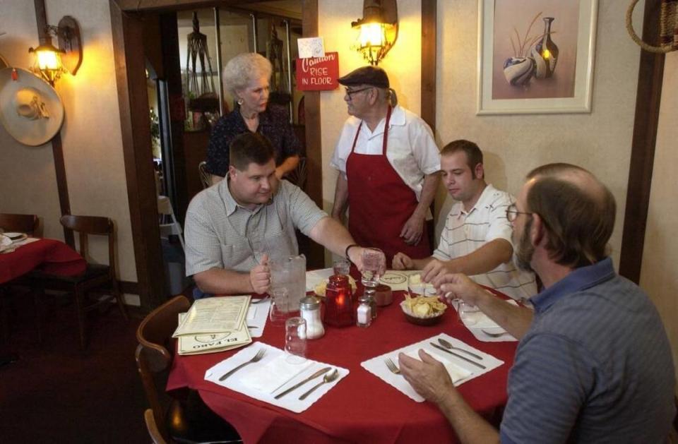 El Faro Restaurant owners Anita and Luis Fregoso, standing, greet long-time customers in 2003.