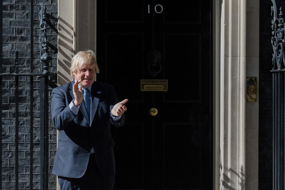 British Prime Minister Boris Johnson claps hands outside 10 Downing Street during the nationwide applause for the NHS staff on the 72nd anniversary of the launch of the National Health Service on 05 July, 2020 in London, England. (Photo by WIktor Szymanowicz/NurPhoto via Getty Images)