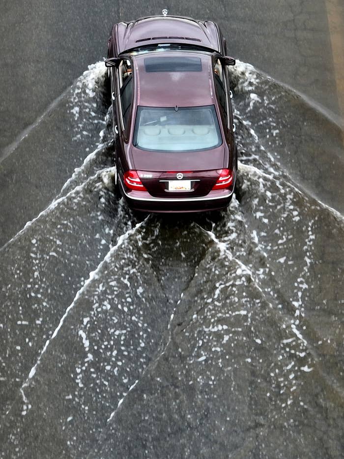 A car drove through a water-covered street in Crisfield, Maryland, on Sunday.