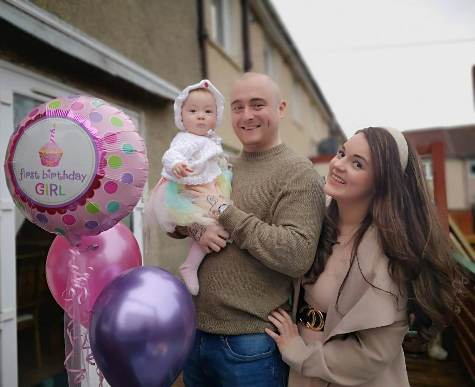 Peyton is celebrating her first birthday at the end of March, pictured with her mum and dad, Tracy and AJ. (PA Real Life)