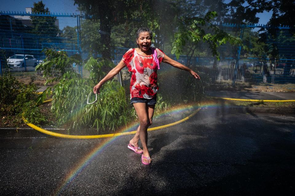 Governments and communities have been implementing strategies such as setting up misting stations for people to stay safe during extreme heat. THE CANADIAN PRESS/Darryl Dyck