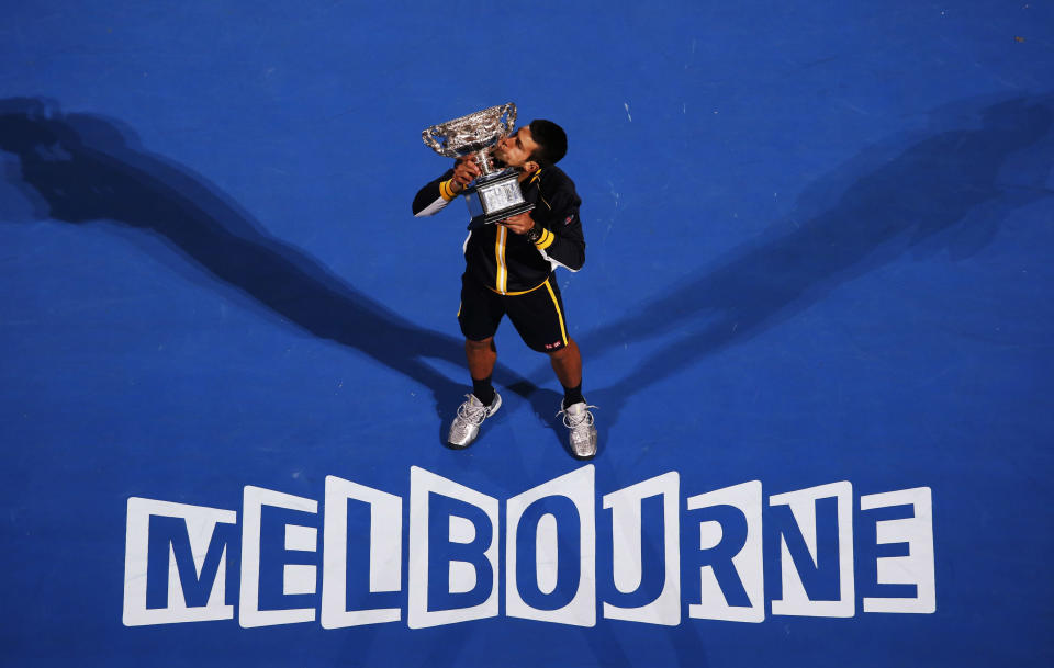 Novak Djokovic of Serbia poses with the Norman Brookes Challenge Cup after defeating Andy Murray of Britain in their men's singles final match at the Australian Open tennis tournament in Melbourne, January 27, 2013. REUTERS/David Gray (AUSTRALIA - Tags: SPORT TENNIS TPX IMAGES OF THE DAY) - RTR3D19I