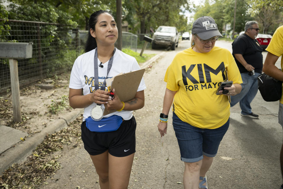 Uvalde mayoral candidate Kimberly Mata-Rubio, left, and campaign manager Dr. Laura Barberena, canvass a neighborhood in support of Mata-Rubio's campaign, Saturday, Oct. 21, 2023, in Uvalde, Texas. (AP Photo/Darren Abate)