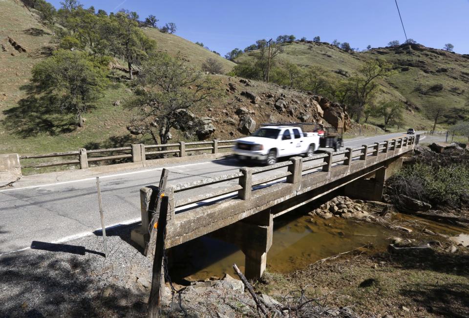 A vehicle crosses a bridge over Stone Corral Creek Wednesday, March 19, 2014, near Maxwell, Calif. The would be replaced by the proposed Sites Dam creating the Sites Reservoir. In a show of bipartisanship, Democratic Rep. John Garamendi and Republican Rep. Doug LaMalfa proposed legislation Wednesday, for a federal study of the costs of building the Sites Reservoir. (AP Photo/Rich Pedroncelli)