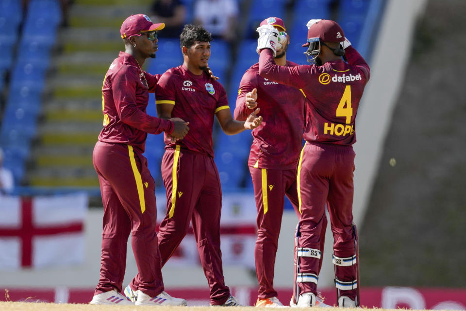 West Indies' Gudakesh Motie celebrates the dismissal of England's Phil Salt during the first ODI cricket match at Sir Vivian Richards Stadium in North Sound, Antigua and Barbuda, Sunday, Dec. 3, 2023. (AP Photo/Ricardo Mazalan)