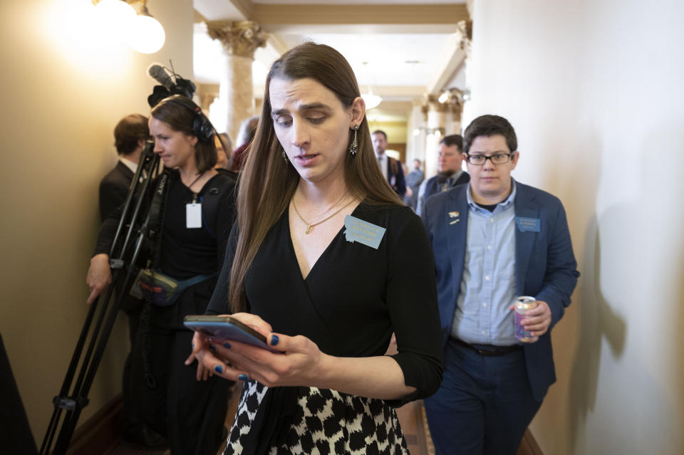 Rep. Zooey Zephyr looks on after speaking with the media at the Montana State Capitol in Helena, Mont., on Wednesday, April 26, 2023. Republicans in Montana's House of Representatives voted to ban Zephyr from the House floor for the rest of the 2023 session on Wednesday in retaliation for her rebuking colleagues – and then participating in protests – after they voted to ban gender-affirming care for children. (AP Photo/Tommy Martino)