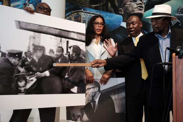 Mustafa Hassan, 84, an associate of Malcolm X, points to himself in a picture following the assassination of Malcolm X during a news conference with Civil rights attorney, Ben Crump, and Malcolm X's daughter, IIyasah Shabazz, on Tuesday in New York City. They allege more information has been discovered which they say points to efforts by the FBI to cover up a conspiracy to murder Malcolm X. 