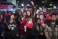 Basketball fans cheer for the Toronto Raptors before claiming victory over the Philadelphia 76ers outside Maple Leaf Square during the second half of an NBA Eastern Conference semifinal basketball game in Toronto on Sunday, May 12, 2019. (Tijana Martin/The Canadian Press via AP)