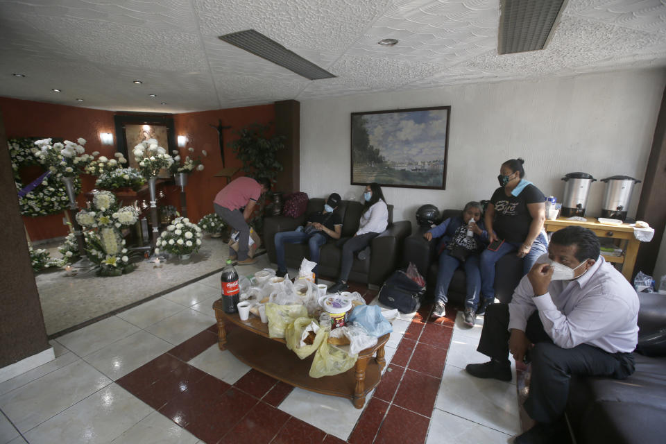 Friends and family attend a wake honoring Liliana Lopez, 37, who died in the Mexico City Metro collapse disaster, at a funeral home in Mexico City Wednesday, May 5, 2021. Monday night’s accident was one of the deadliest in the history of the capital's subway system. (AP Photo/Marco Ugarte)