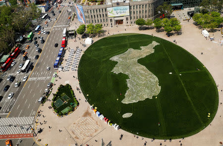 The shape of the Korean peninsula is seen on the lawn in front of City Hall ahead of the upcoming summit between North and South Korea in Seoul, South Korea April 25, 2018. REUTERS/Jorge Silva