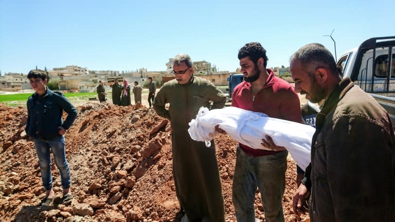 Syrians bury the bodies of victims of a a suspected chemical attack in Khan Sheikhun, a rebel-held town in Syria’s northwestern Idlib province, on April 5, 2017