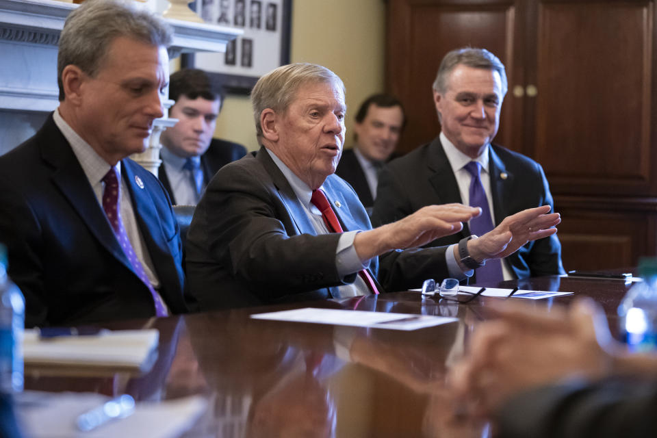 FILE- In this Feb. 14, 2019, file photo, Sen. Johnny Isakson, R-Ga., flanked by Rep. Buddy Carter R-Ga., left, and Sen. David Perdue, R-Ga., right, leads a meeting on Capitol Hill in Washington. Sen. Isakson announced on Wednesday, Aug. 28, 2019, that he will retire at the end of 2019, citing "health challenges." (AP Photo/J. Scott Applewhite, File)