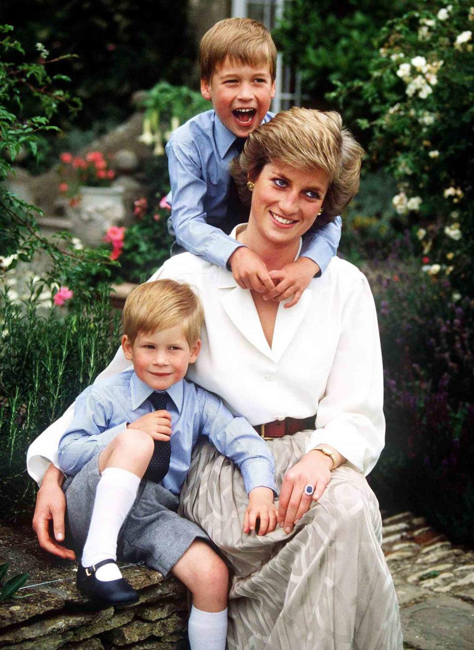 A young (elementary age) Prince William laughing with his arms around his smiling mother, the late Princess Diana.