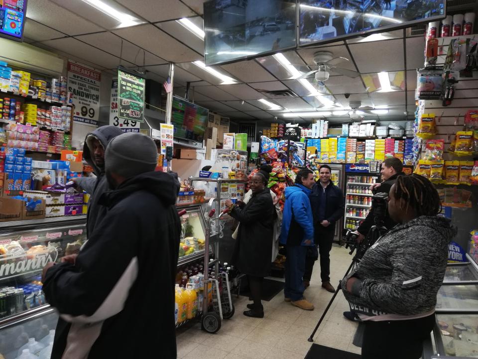 People are shown inside the West Harlem Deli, Sunday, Oct. 28, 2018, in New York. One of two Powerball tickets that hit the $688 million jackpot was sold at the store. (AP Photo/Julie Walker)