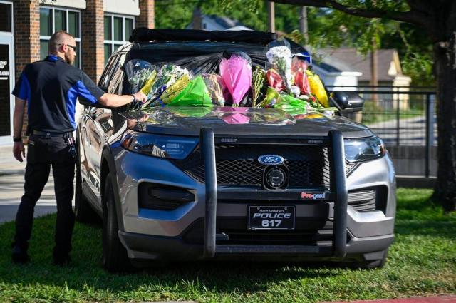 One day after North Kansas City Police officer Daniel Vasquez was fatally shot, Jon Campbell paid tribute to his friend, the fallen officer, whose police vehicle was laden with flowers on Wednesday, July 20, 2022, outside the North Kansas City Police Department. Campbell, an employee at Harrah’s Casino, came to know Vasquez through his security work at the casino.