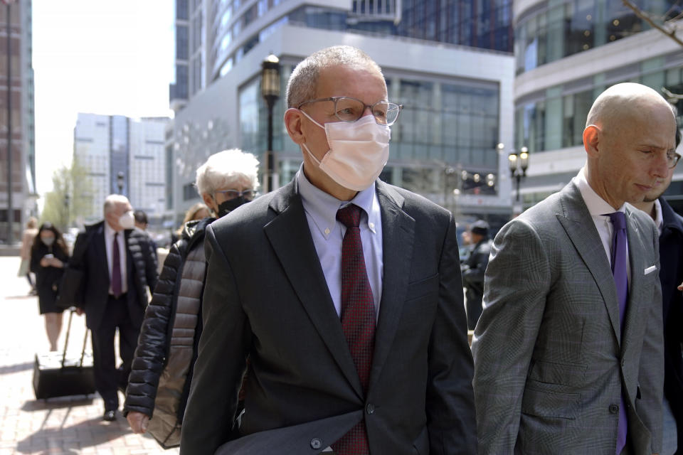 Charles Lieber, center, departs federal court in Boston, Wednesday, April 26, 2023. Lieber, a former Harvard University professor convicted of lying to federal investigators about his ties to a Chinese-run science recruitment program and failing to pay taxes on payments from a Chinese university, was sentenced Wednesday to supervised release and ordered to pay more than $83,000 in restitution and fines. (AP Photo/Steven Senne)