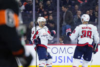 Washington Capitals' Alex Ovechkin, center, and Anthony Mantha celebrate after Ovechkin's goal during the third period of an NHL hockey game against the Philadelphia Flyers, Wednesday, Dec. 7, 2022, in Philadelphia. (AP Photo/Matt Slocum)