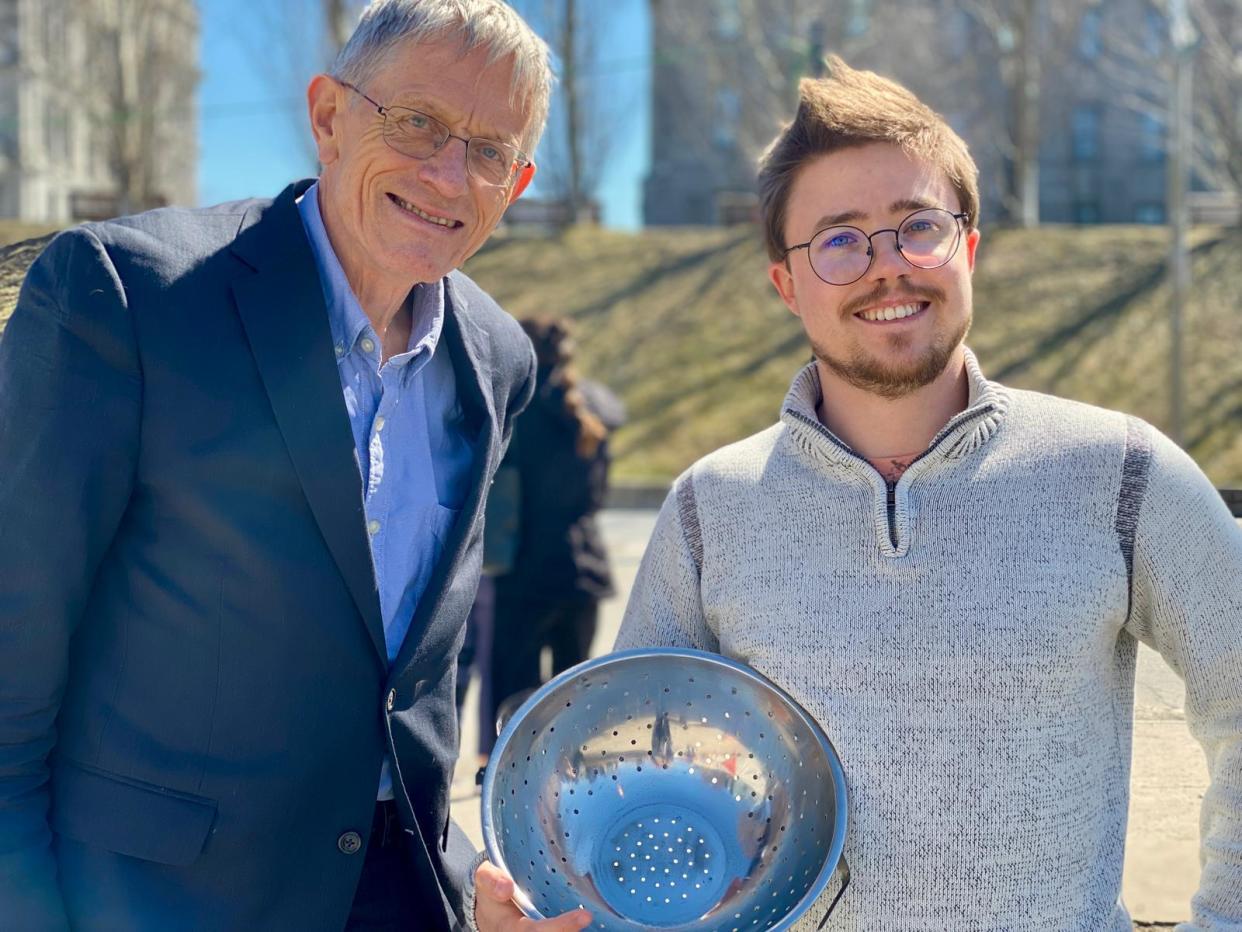 Student Sam (right) with colander and Simon Calder (The Independent)