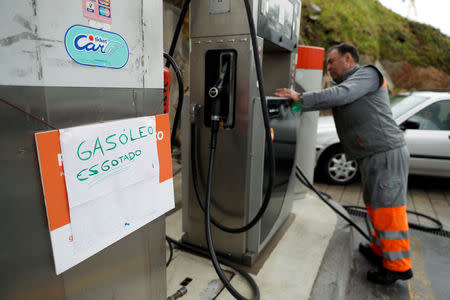 A placard reading "Diesel sold out" is seen at a gas station in Porto, Portugal April 17, 2019. REUTERS/Rafael Marchante