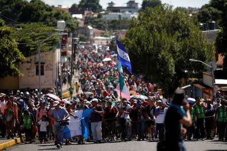 FILE PHOTO: Central American migrants, who are part of a caravan of migrants trying to reach the United States, walk on a street as they continue their journey in Tapachula, Mexico October 22, 2018. REUTERS/Ueslei Marcelino/File Photo