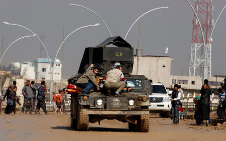 A wounded Iraqi is evacuated as Iraqi forces battle with Islamic State militants, in western Mosul, Iraq March 24, 2017. REUTERS/Suhaib Salem