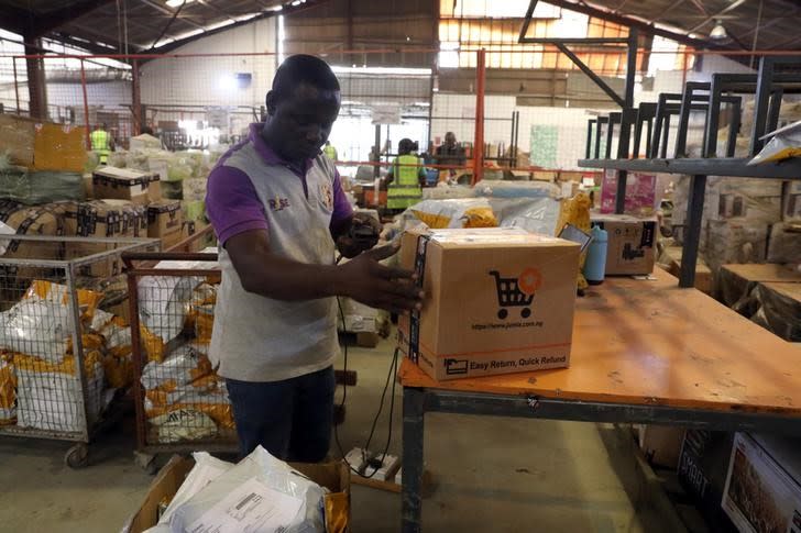 Worker of the Jumia company tags a package at the warehouse in Lagos