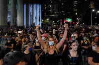 Protesters chant slogans during a protest to defund the police in a place they are calling the "City Hall Autonomous Zone" in support of "Black Lives Matter" in the Manhattan borough of New York City