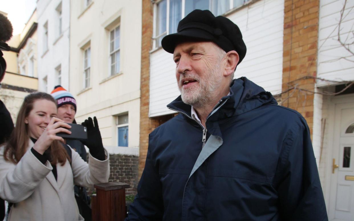 Jeremy Corbyn, the Labour leader, wearing a so-called 'Lenin cap' - PA