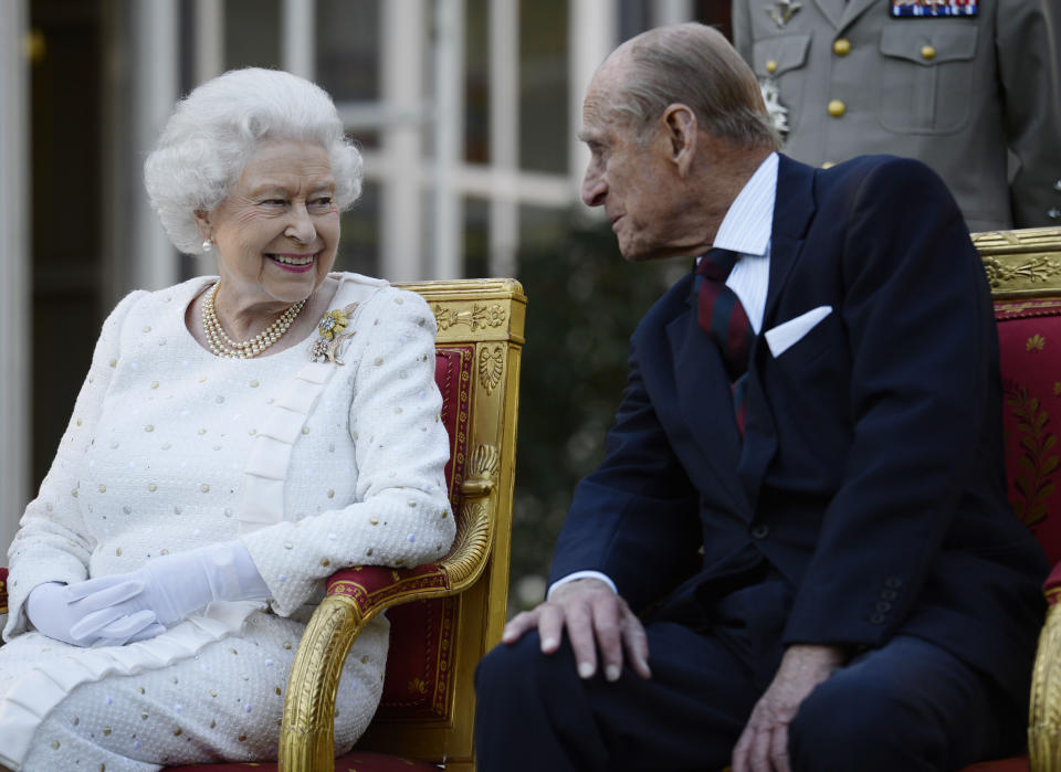 File photo dated 5/6/2014 of Queen Elizabeth II and the Duke of Edinburgh attend a garden party in Paris, hosted by Sir Peter Ricketts, Britain's Ambassador to France ahead of marking the 70th anniversary of the D-Day landings during World War II. The memorial service for the Duke will pay tribute to Philip's dedication to 