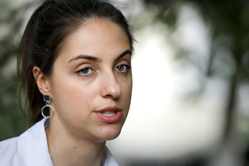 In this photo taken on Wednesday, Aug. 5, 2020, Kseniya Milya, the 26-year old movie producer speaks during her interview with the Associated Press in Minsk, Belarus. When Kseniya Milya's grandfather died of coronavirus in March, the authoritarian leader of Belarusian was dismissing the pandemic as a "psychosis" and offering people to have a shot of vodka for protection. (AP Photo/Sergei Grits)