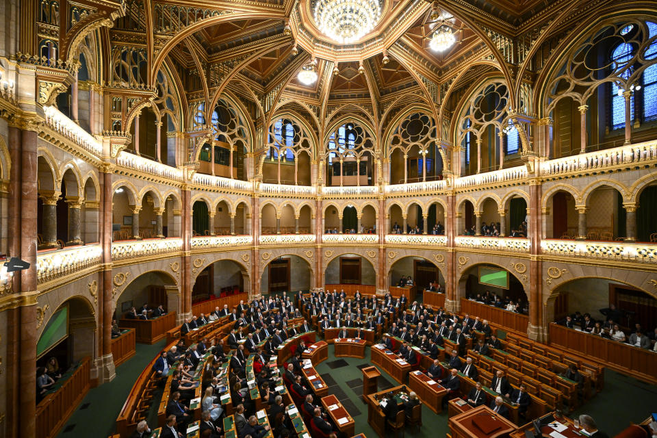 Hungarian Prime Minister Viktor Orban, center right, sits next to Zsolt Semjen, the Hungarian Deputy Prime Minister, before addressing a parliament session, on the day lawmakers are expected to approve Sweden's accession into NATO, in Budapest, Hungary, Monday, Feb 26, 2024. Hungary's parliament is to vote Monday on ratifying Sweden's bid to join NATO, likely bringing an end to more than 18 months of delays that have frustrated the alliance as it seeks to expand in response to Russia's war in Ukraine. (AP Photo/Denes Erdos)