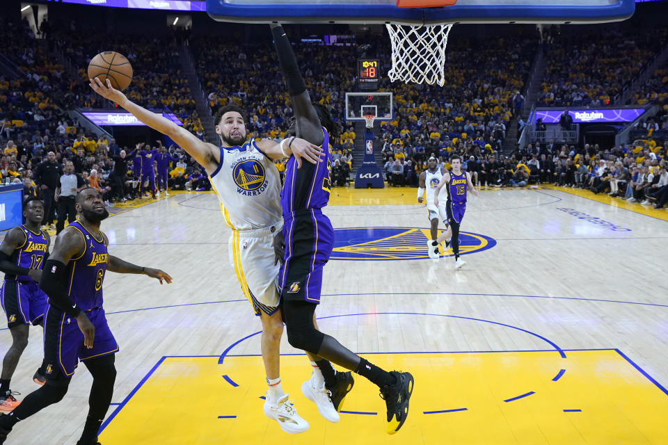 Golden State Warriors guard Klay Thompson (11) shoots against Los Angeles Lakers forward Wenyen Gabriel, right, during the first half of Game 2 of an NBA basketball Western Conference semifinal game, Thursday, May 4, 2023, in San Francisco. (AP Photo/Godofredo A. Vásquez)