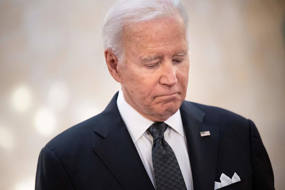 US President Joe Biden looks on as US First Lady Jill Biden, not pictured, signs a book of condolence at Lancaster House in London on September 18, 2022, following the death of Queen Elizabeth II on September 8. - Britain was gearing up Sunday for the momentous state funeral of Queen Elizabeth II as King Charles III prepared to host world leaders and as mourners queued for the final 24 hours left to view her coffin, lying in state in Westminster Hall at the Palace of Westminster. (Photo by Brendan Smialowski / AFP) (Photo by BRENDAN SMIALOWSKI/AFP via Getty Images)