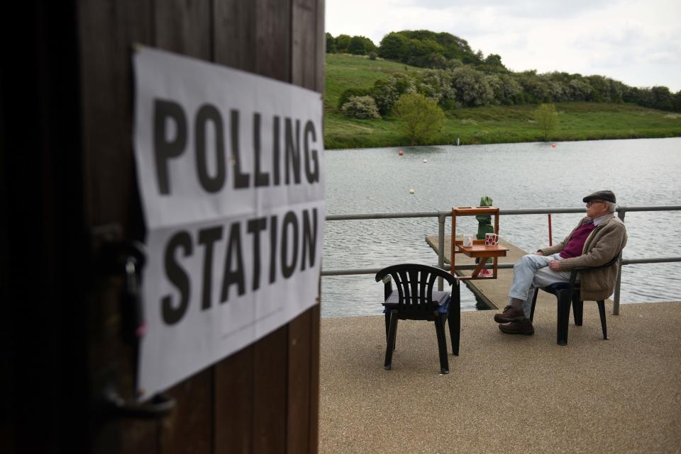 TOPSHOT - A man sits at a polling station set up at the Rawdon Model Boat Club, near Leeds on May 23, 2019, as voting for the European Parliament elections got underway across the country. - Voting got under way in Britain early on Thursday in elections to the European Parliament -- a contest the country had not expected to hold nearly three years after the Brexit referendum. (Photo by Oli SCARFF / AFP)        (Photo credit should read OLI SCARFF/AFP via Getty Images)