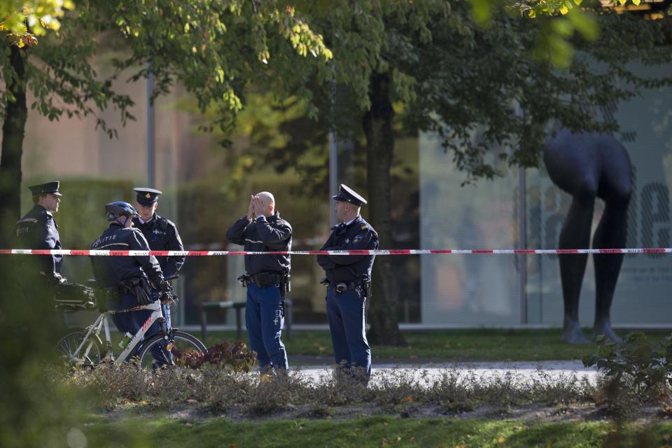 Police officers guard a cordoned off area at the rear side of the Kunsthal museum in Rotterdam, Tuesday Oct. 16, 2012. Several paintings have been stolen from a museum in the Dutch city of Rotterdam that was exhibiting works by Pablo Picasso, Henri Matisse and Vincent van Gogh. At least several paintings were stolen early Tuesday morning from the Kunsthal museum , but their names have not yet been released. They are believed to include at least one by Henri Matisse, the 1919 "Reading Girl." (AP Photo/Peter Dejong)